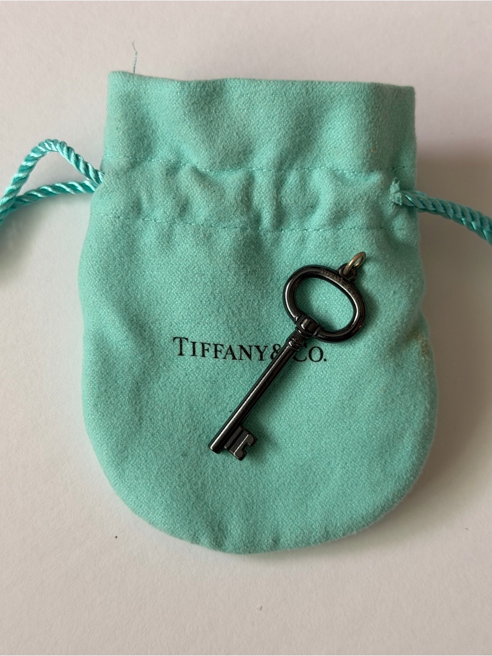 Retired Tiffany & Co. Black
Titanium Oval Key Charm Pendant with Pouch